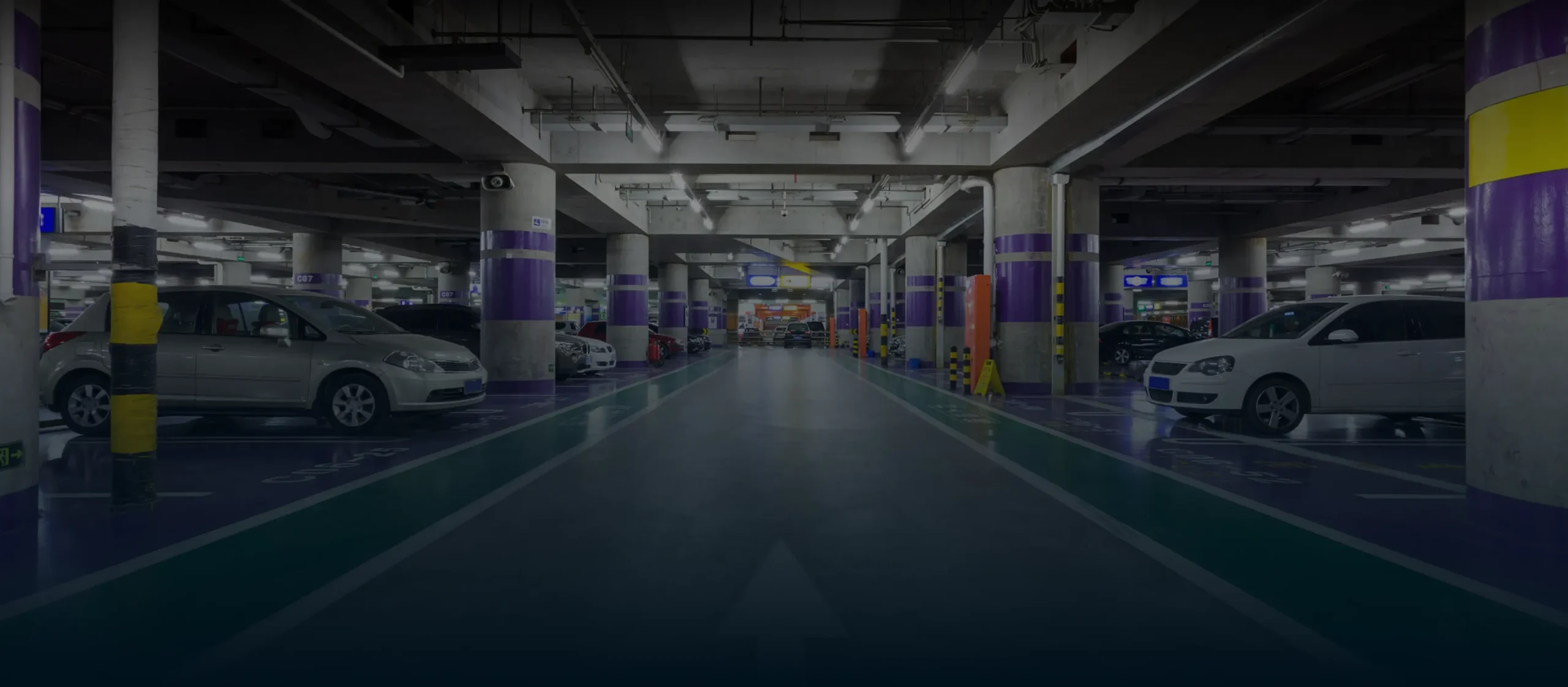 Underground parking lot with parked cars.